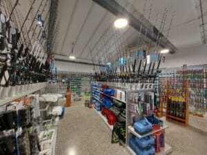 Fishing store gondola with custom rod holders, metal shelves and perf panel for hangsell