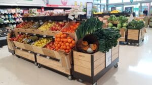 Double layer produce gondola on castors with wood crates and dumpbin end