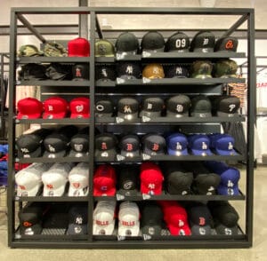 Large metal framed hat display stand with angled mesh shelves