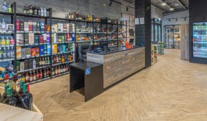 Modular liquor store wall shelving system with adjustable height and LED downlit shelves