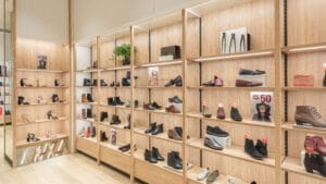 Footwear wall display system with adjustable height shelves