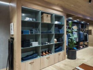 Wall system for apparel with cubby holes, LED downlighting and base storage
